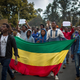 Thousands of protestors from the capital and those displaced by ethnic-based violence over the weekend in Burayu, demonstrate to demand justice from the government in Addis Ababa, Ethiopia Monday, Sept. 17, 2018. Several thousand Ethiopians have gone out onto the streets of the capital to protest ethnic-based attacks in the outskirts of the city in which more than 20 people died over the weekend. Three banners in Amharic from left to right read "Justice for the people of Amhara, Tigray and Southerners", "Stop ethnic-based attacks" and "One mouth, but two tongues".